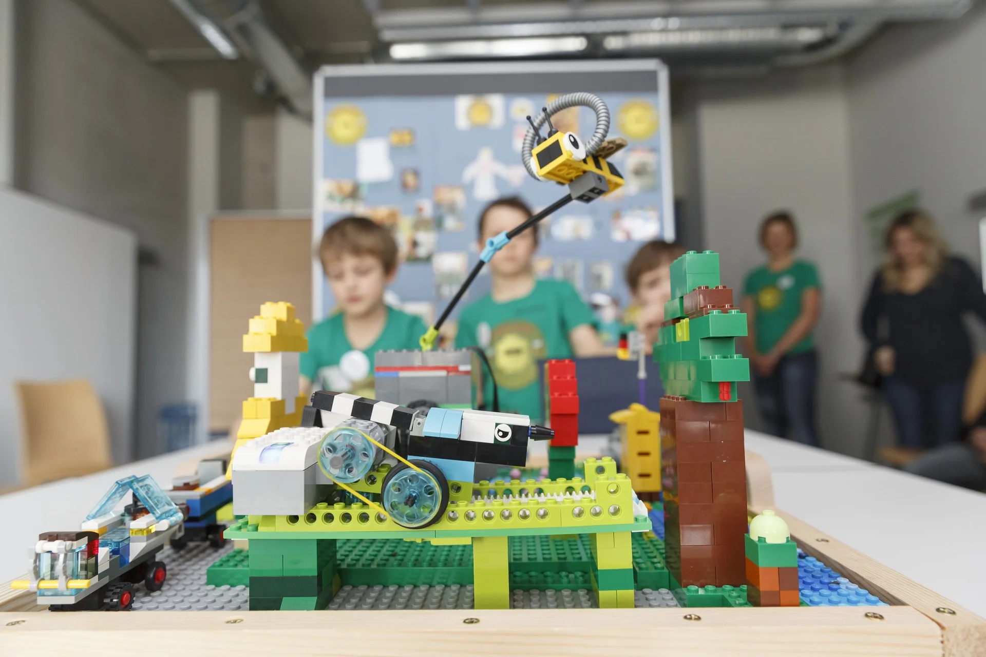 young students with lego robot