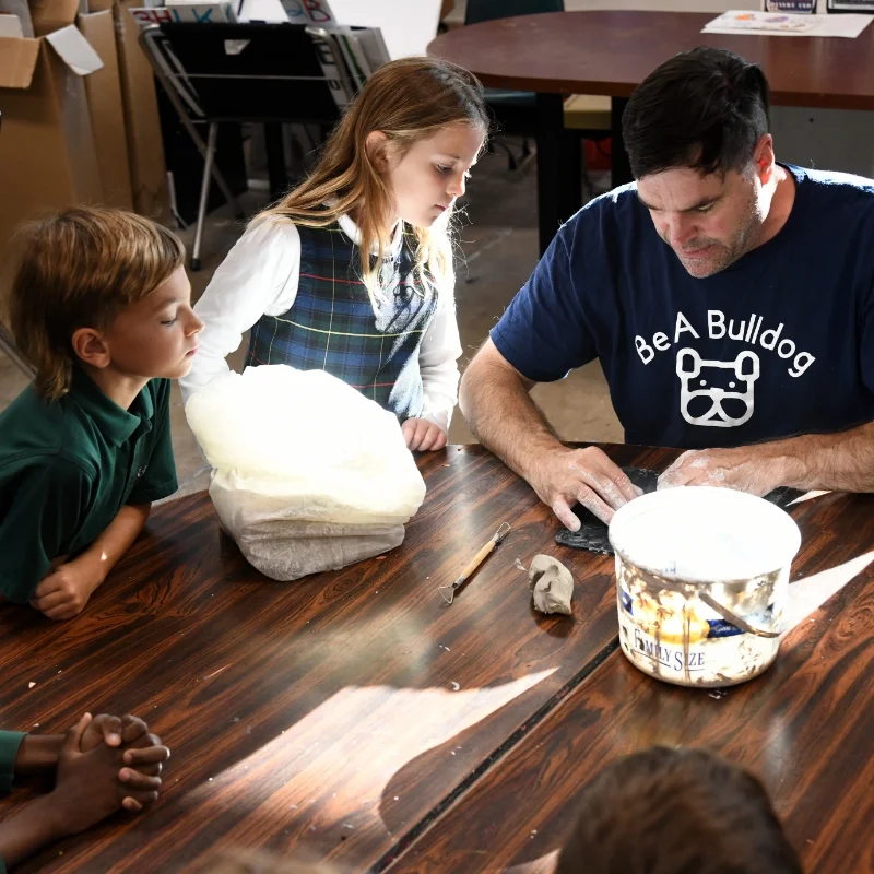 students watching teacher demonstrate ceramics