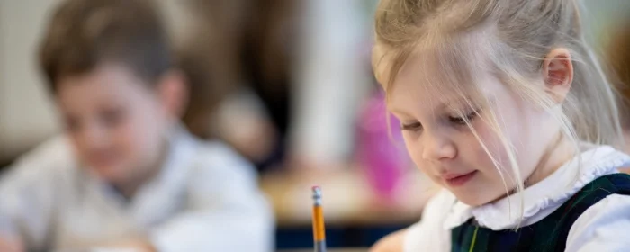 students writing on paper