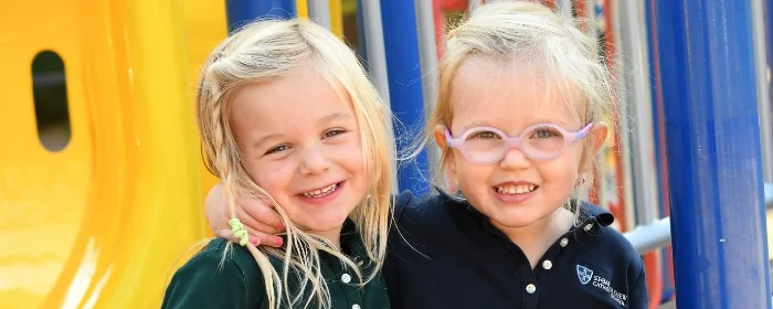 two studens smiling on playground